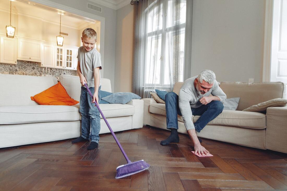 A father and a son cleaning the floor